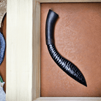 Stoneblade Forge hand-knapped black obsidian kukri with curved wooden handle displayed in a wooden presentation tray