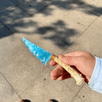 Stoneblade Forge blue opalite crystal dagger with antler handle held outdoors in natural sunlight