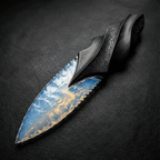 Stoneblade Forge hand-knapped blue opalite crystal dagger with carved black wooden handle on black textured background