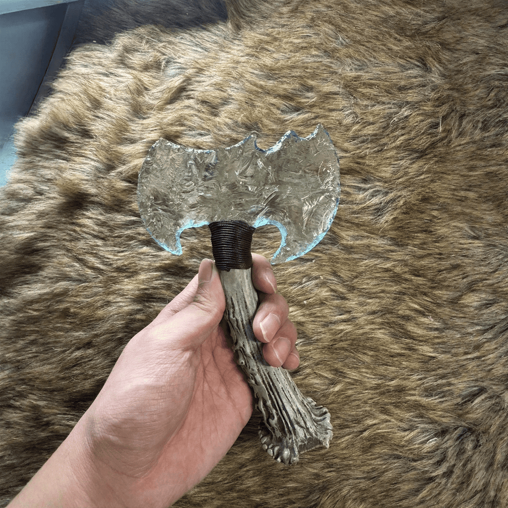 Handheld view of Ghostcleaver clear crystal axe head showing frosted texture and wrap collar