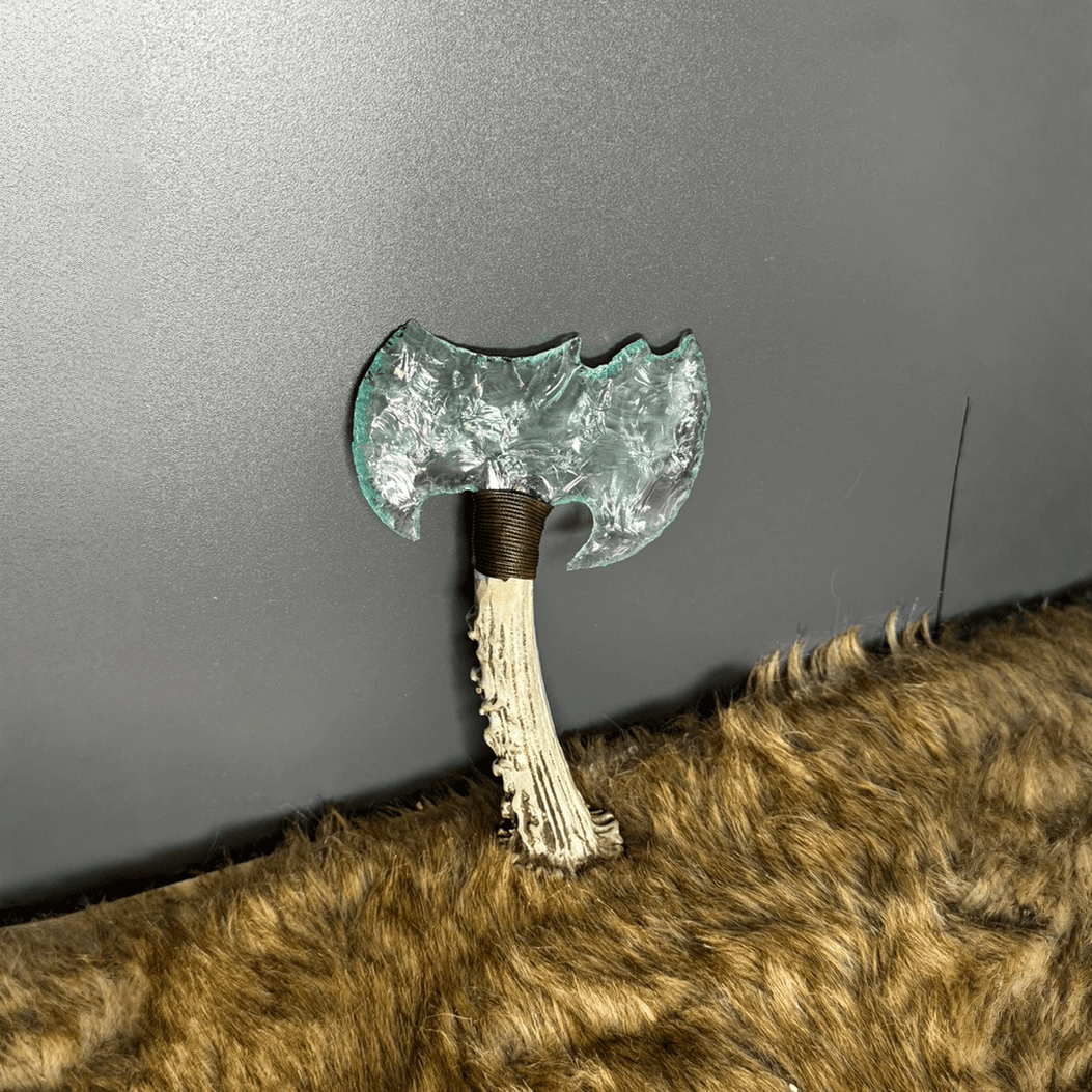 Ghostcleaver clear crystal stone axe standing on fur surface with antler handle detail