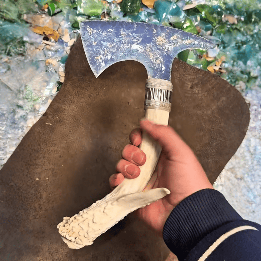 Moonveil opal stone blade axe in hand showing antler handle and wrapped collar detail