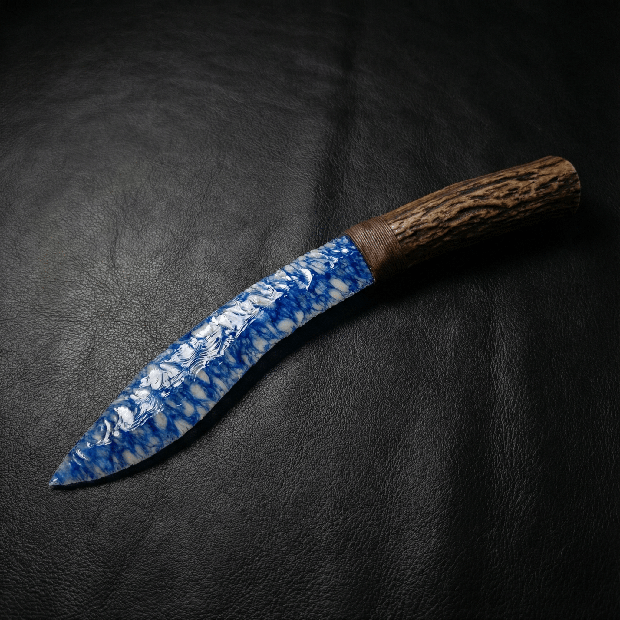 Claw Stone Blade — Abysscrest (Ocean Blue, Crystal), curved blade on black leather background