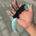 Ice-blue crystal claw stone blade in hand on stone pavement, angled view