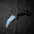 Opal-blue crystal claw stone blade with golden iridescence on black leather background, top view