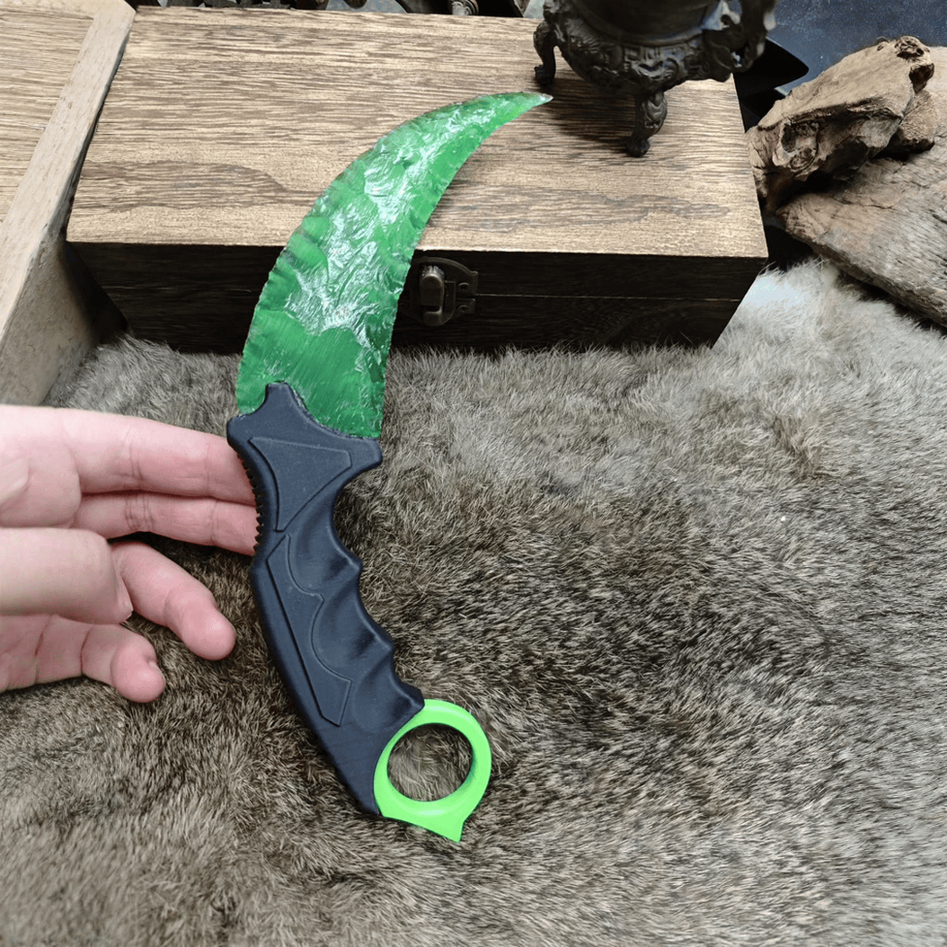 Green crystal claw stone blade on fur surface with wood box background, full view