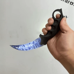Blue crystal claw stone blade in hand, angled view