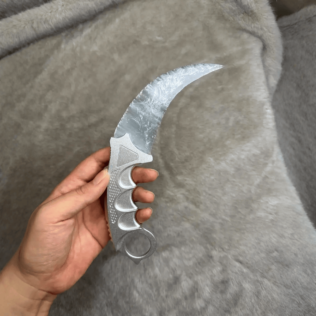 Close-up of silver cat’s eye stone blade texture and crescent claw profile