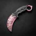 Pink crystal claw stone blade on black leather background, top view