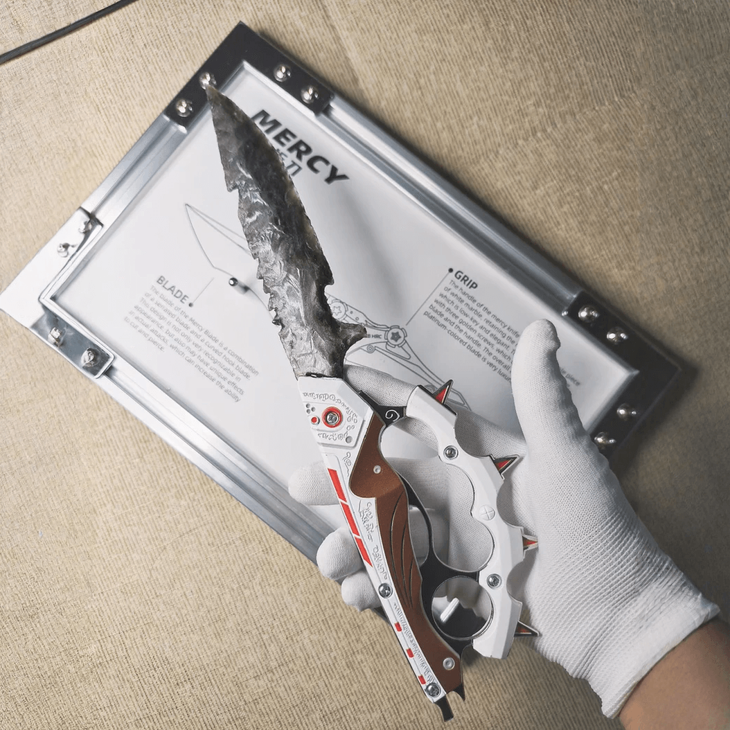 Gloved-hand close-up holding the grey knapped-style dagger with red-and-white mechanical-style handle over the “MERCY” board (Delta Force).