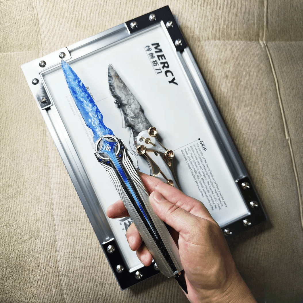 Handheld close-up of the blue crystal-like dagger with metallic handle, held above the “MERCY” display board (Delta Force).