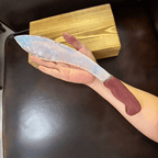 Handheld view of Auroraflare curved opal blade showing translucent texture and long crescent profile