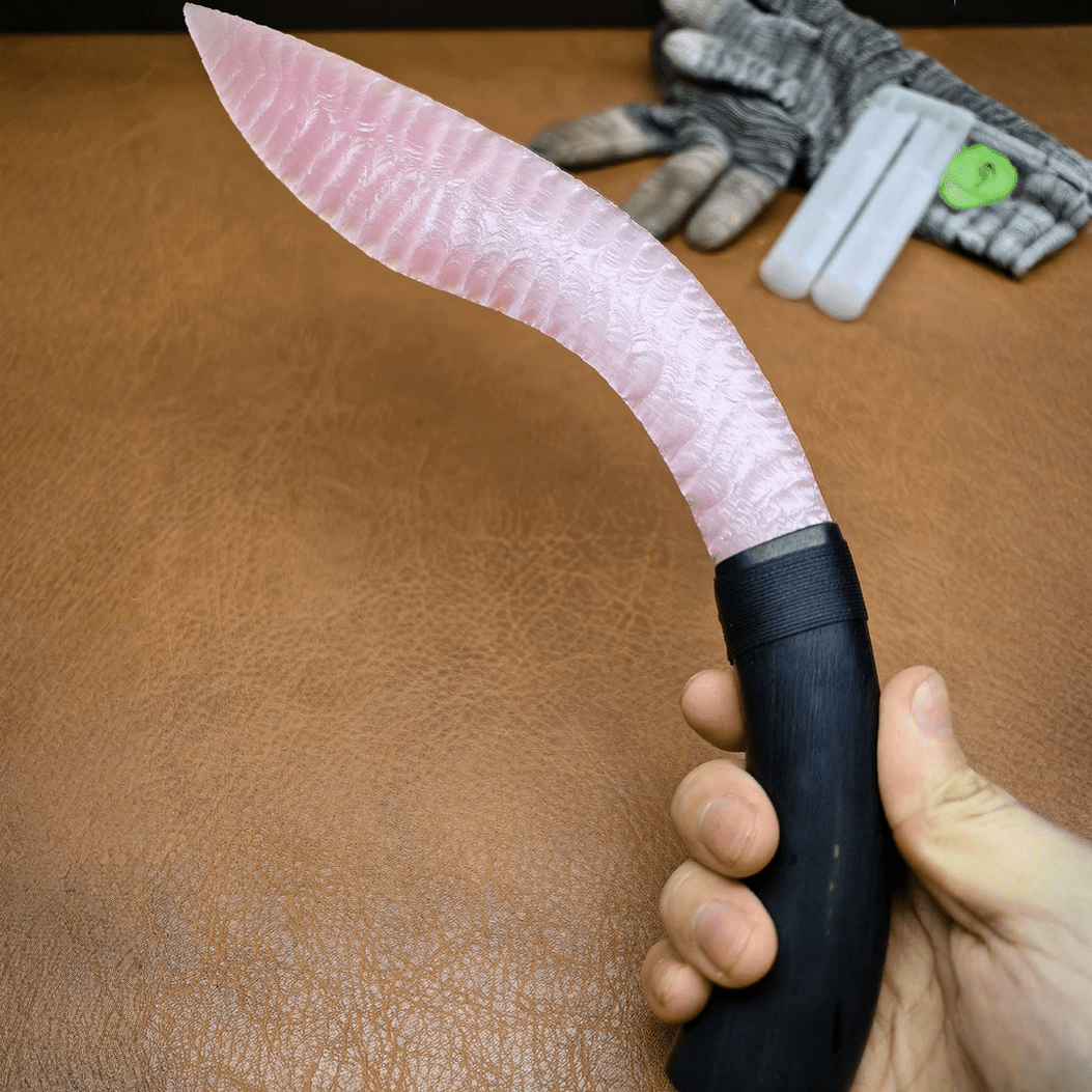 Angled handheld view of Nightbloom blush crystal curved blade with long crescent profile
