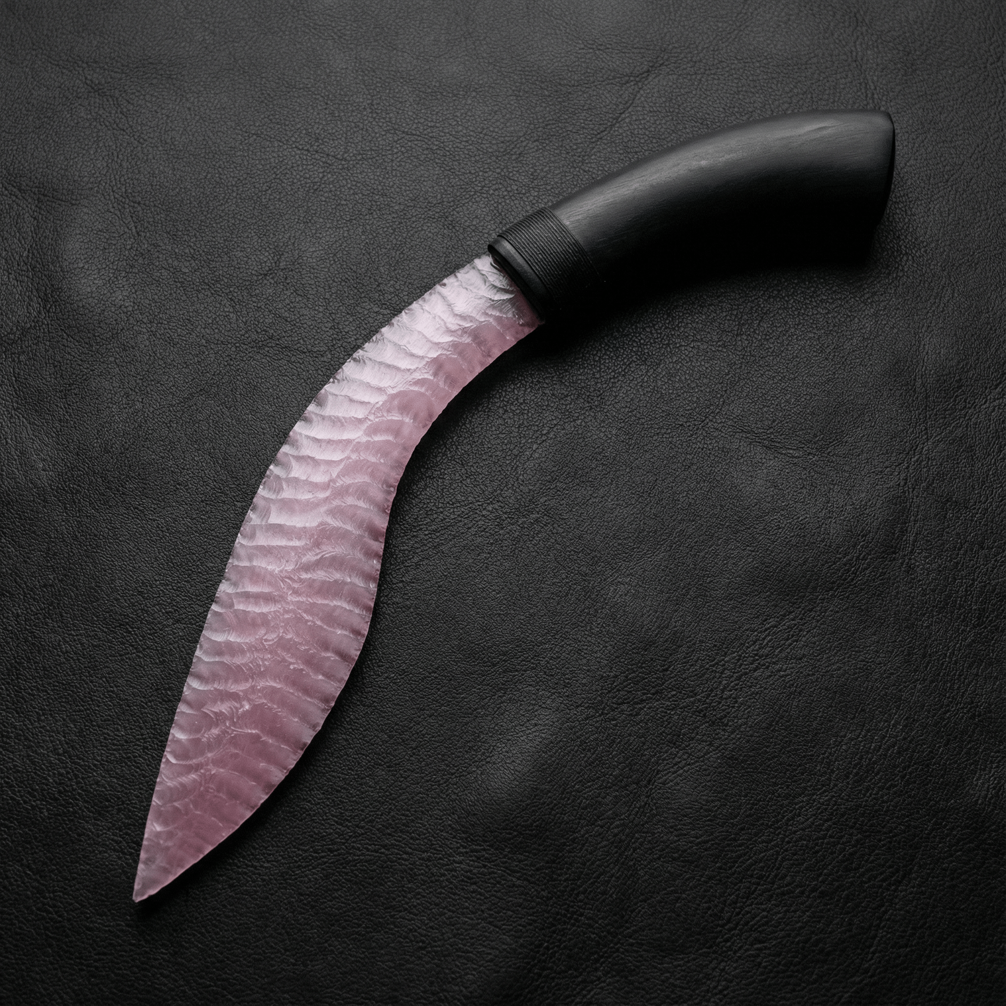 Blush pink rose quartz Curved Stone Blade Nightbloom on black leather background