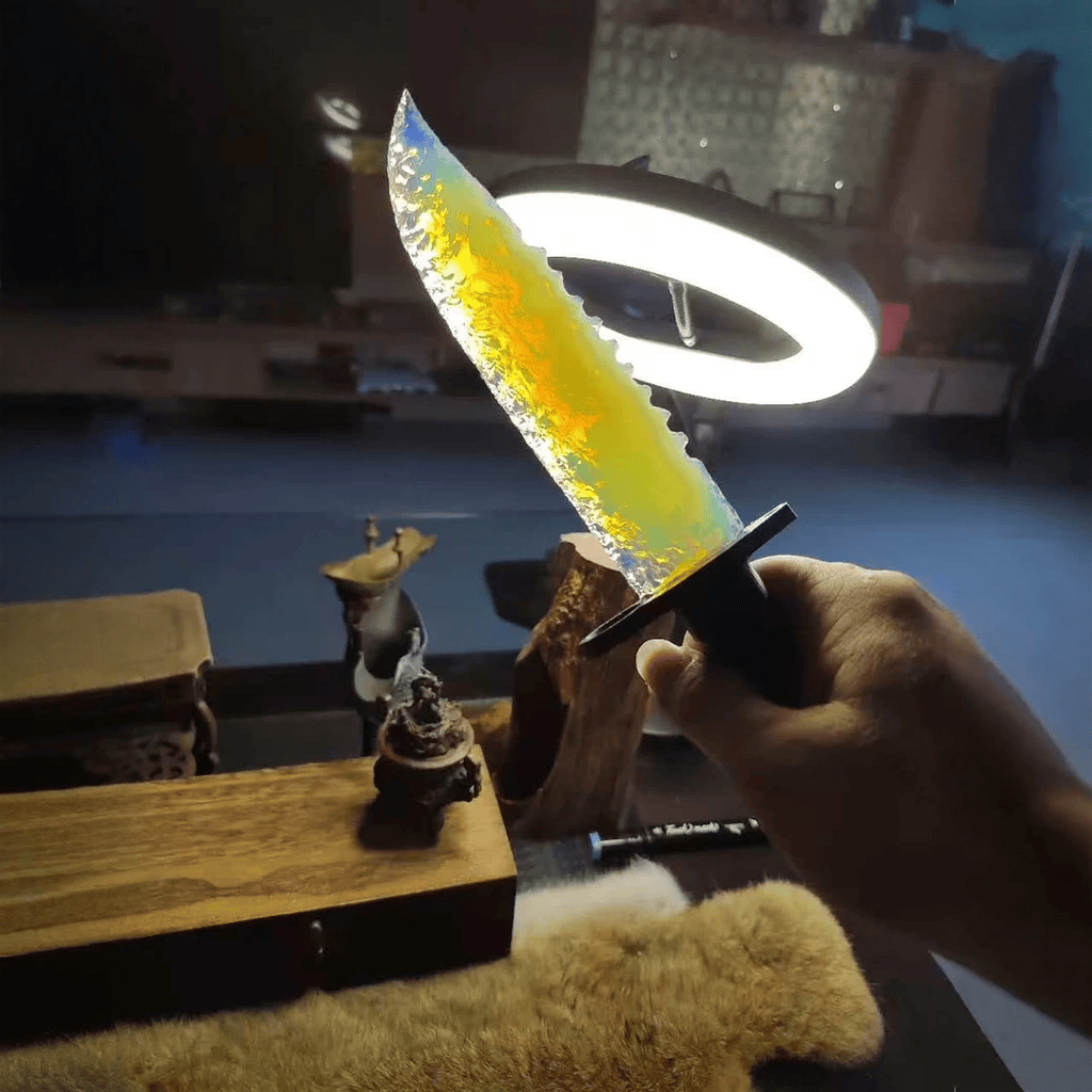 Stoneblade Forge Dagger Stone Blade “Frostveil” — handheld shot under a ring light, highlighting the translucent blade glow and serrated knapped edge texture.