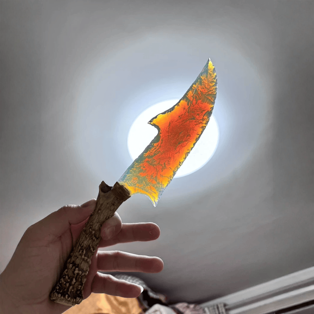 Stoneblade Forge Dagger Stone Blade “Ghostglass” — backlit translucent blade glowing amber-orange, highlighting flake scars and jagged edge.