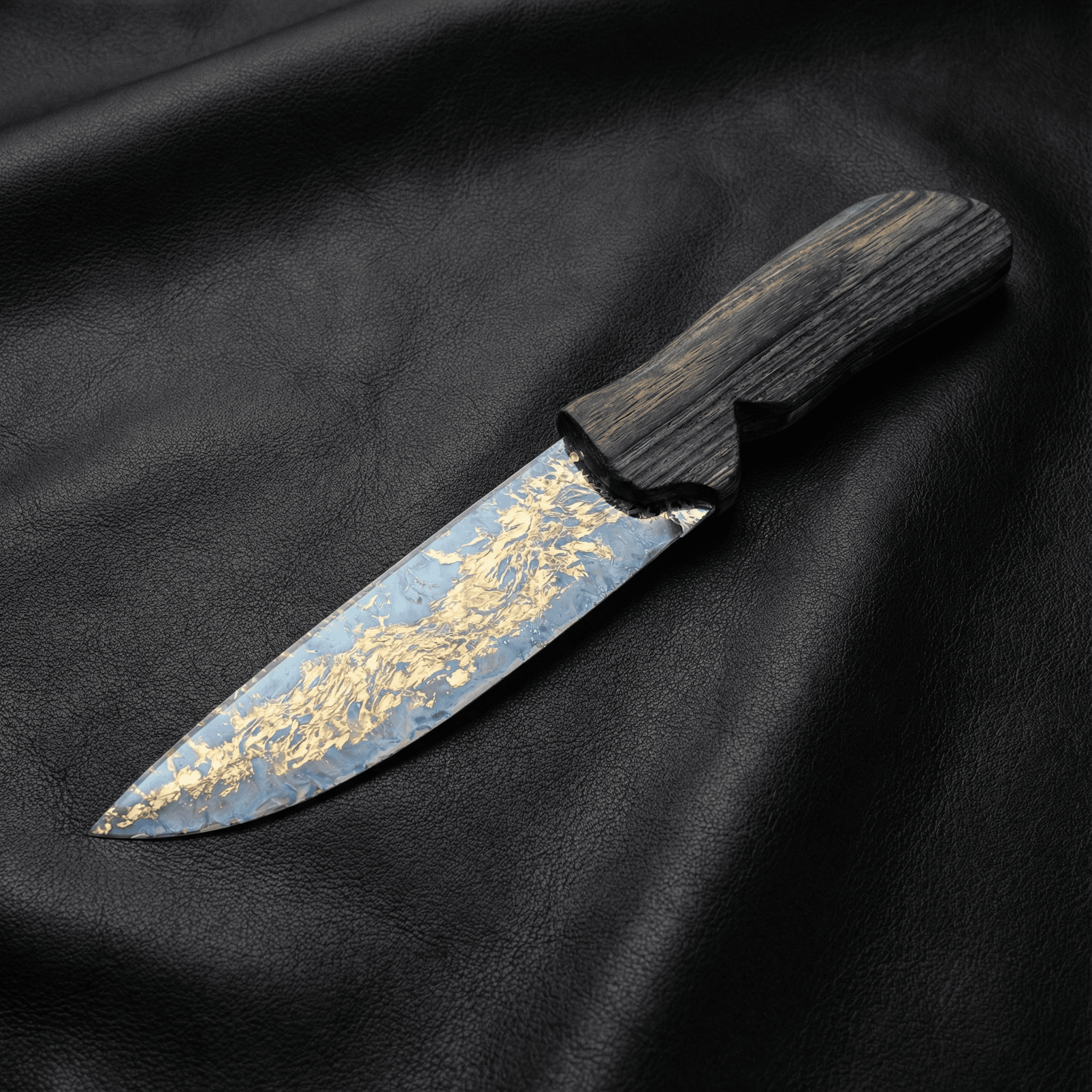 Stoneblade Forge Dagger Stone Blade “Gildveil” — silver-toned stone dagger with gold-vein pattern and dark wood handle styled on black leather.