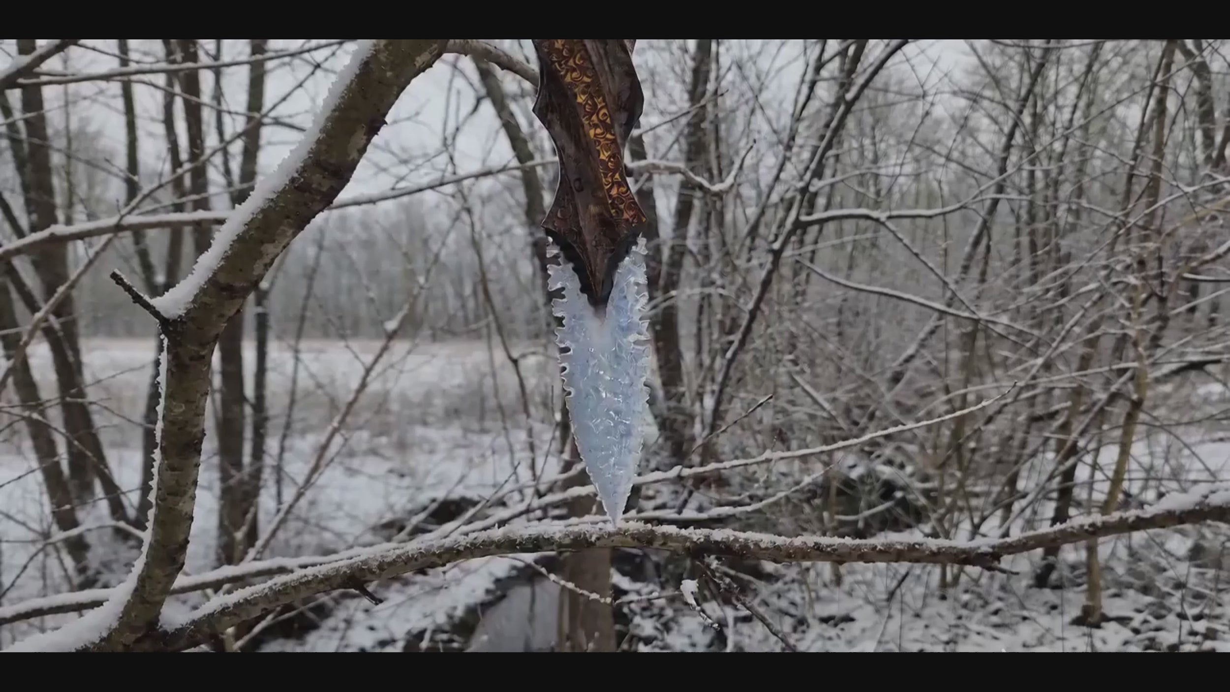 Stoneblade Forge Blade of Oblivion video showing an icy crystal dagger with carved wooden handle held in a snowy forest scene