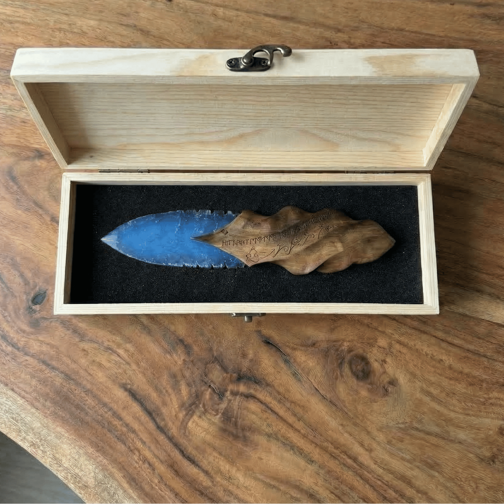 Stoneblade Forge blue crystal dagger with carved wooden handle displayed in open wooden gift box on natural wood table