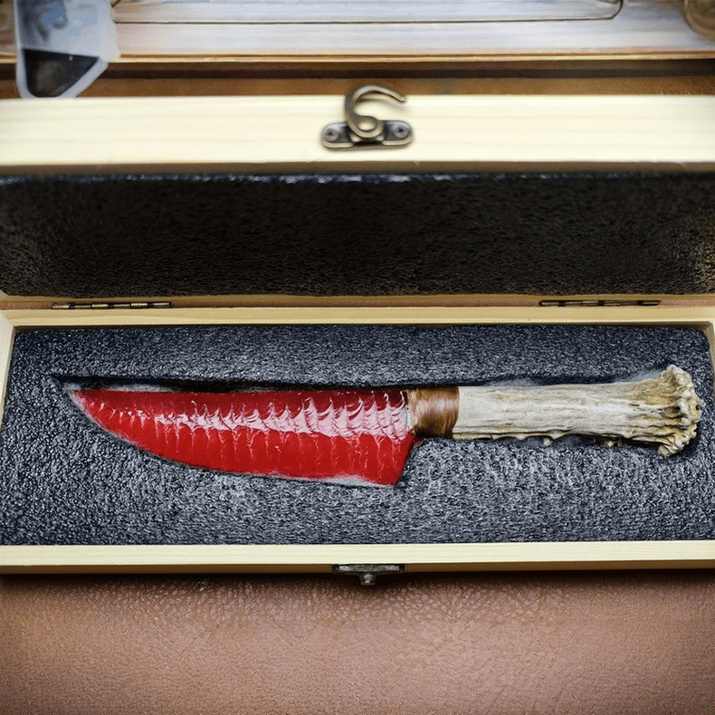 Marauder obsidian crystal dagger held in hand, angled view with wooden box behind