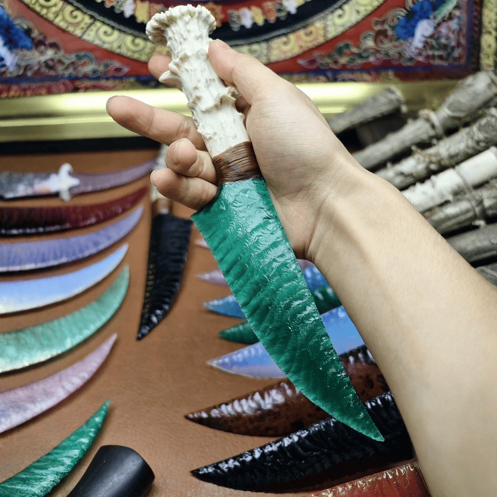 Marauder obsidian dagger held in hand on leather mat with wooden case in the background