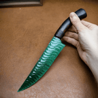 Close-up of Marauder obsidian dagger blade and handle, hand-held on leather mat